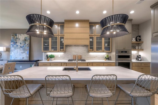 kitchen featuring a large island, pendant lighting, a breakfast bar, and appliances with stainless steel finishes