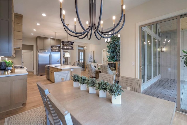 dining area featuring sink and light hardwood / wood-style floors