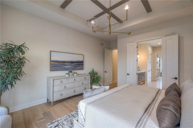 bedroom with beam ceiling, coffered ceiling, a notable chandelier, and light wood-type flooring