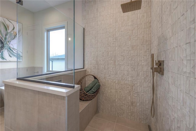 bathroom featuring tile walls, tile patterned flooring, and a shower