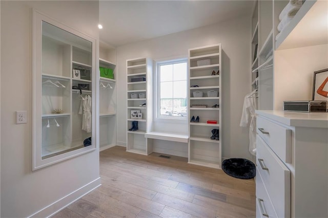 spacious closet featuring light hardwood / wood-style floors