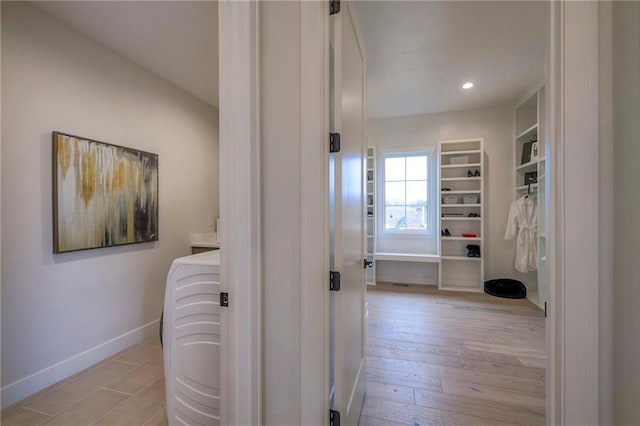 hall featuring washer / dryer and light hardwood / wood-style flooring