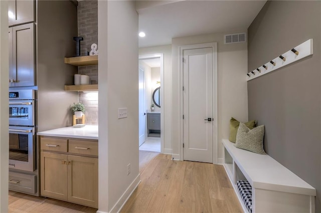 mudroom with light hardwood / wood-style flooring