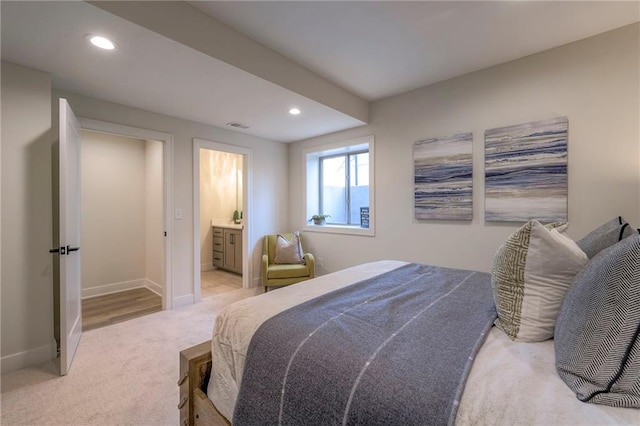 carpeted bedroom with ensuite bathroom