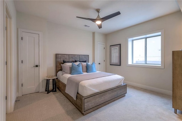 bedroom featuring light colored carpet and ceiling fan