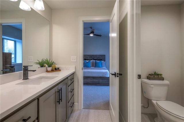 bathroom with vanity, ceiling fan, and toilet