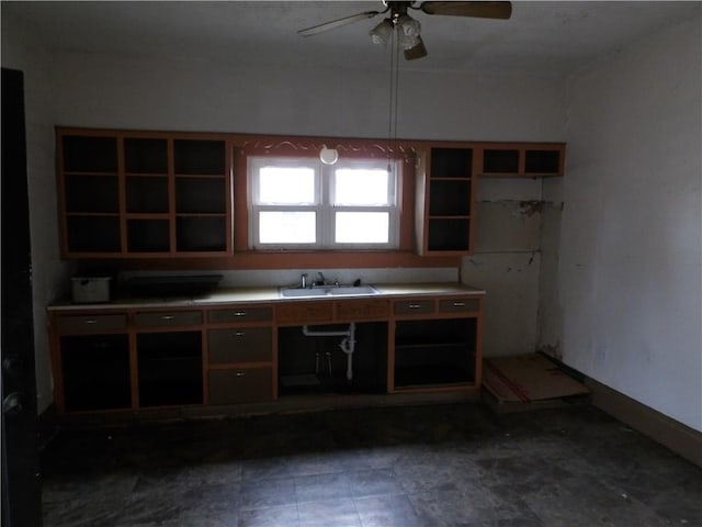 kitchen featuring ceiling fan and sink