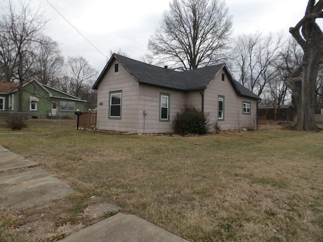 view of side of home featuring a yard