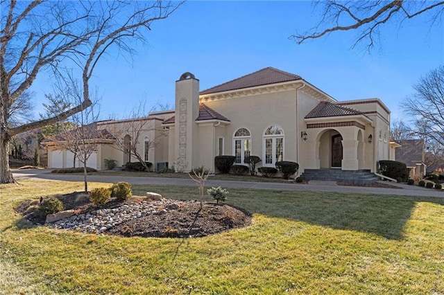 view of front of house featuring a garage, french doors, stucco siding, a chimney, and a front yard