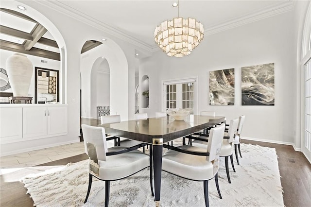 dining area featuring a chandelier, coffered ceiling, baseboards, ornamental molding, and beamed ceiling