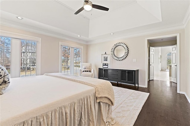 bedroom featuring dark wood finished floors, recessed lighting, a raised ceiling, ornamental molding, and baseboards