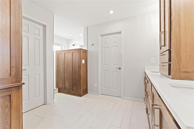 bathroom featuring baseboards and recessed lighting