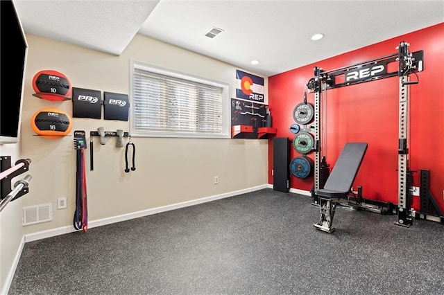 exercise area featuring recessed lighting, visible vents, and baseboards