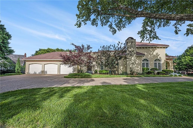 4101 W 123rd St, Leawood, KS 66209 - view of front of home featuring concrete driveway, a front yard, a garage, and stucco siding