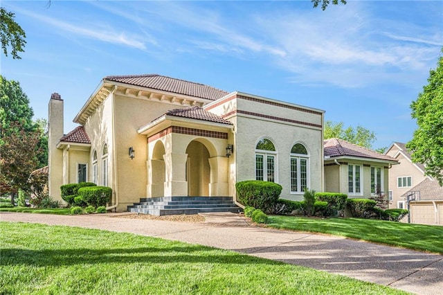 4101 W 123rd St, Leawood, KS 66209 - mediterranean / spanish-style house with a tile roof, a front lawn, stucco siding, and a chimney