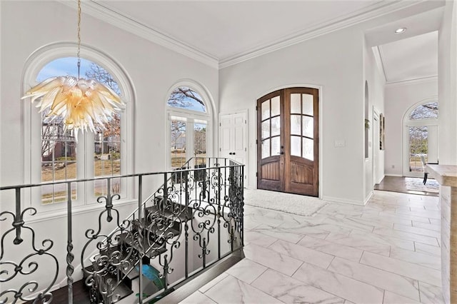 4101 W 123rd St, Leawood, KS 66209 - entrance foyer with crown molding, french doors, marble finish flooring, baseboards, and a chandelier