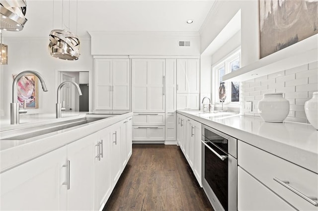 4101 W 123rd St, Leawood, KS 66209 - kitchen with ornamental molding, a sink, light countertops, white cabinets, and recessed lighting