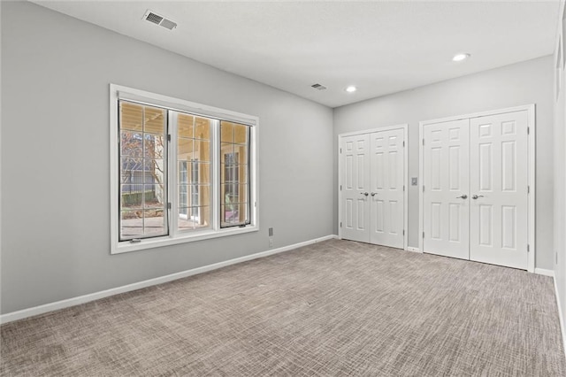 4101 W 123rd St, Leawood, KS 66209 - unfurnished bedroom with two closets, carpet flooring, and recessed lighting