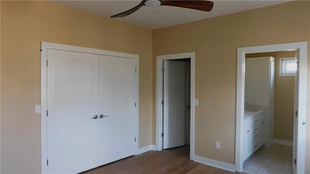 unfurnished bedroom with a ceiling fan, baseboards, a closet, and wood finished floors