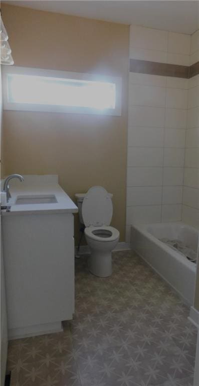 full bathroom with tub / shower combination, vanity, toilet, and tile patterned floors