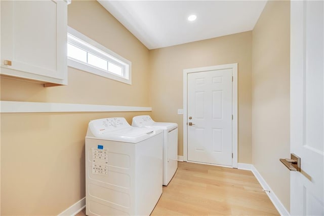 1013 S Main St, Holden, MO 64040 - laundry room with baseboards, washer and clothes dryer, light wood-style floors, and cabinet space