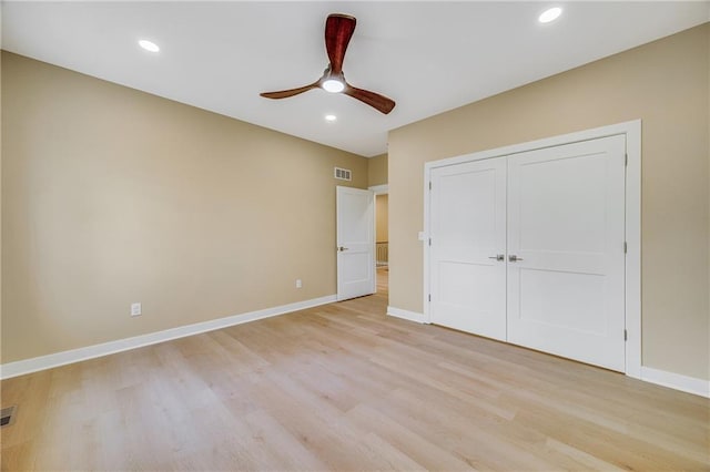 1013 S Main St, Holden, MO 64040 - unfurnished bedroom with light wood finished floors, baseboards, recessed lighting, visible vents, and a closet