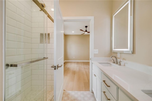 1013 S Main St, Holden, MO 64040 - bathroom featuring a sink, double vanity, a stall shower, baseboards, and ceiling fan
