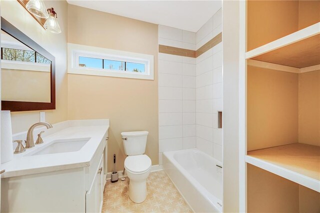 1013 S Main St, Holden, MO 64040 - bathroom featuring toilet, vanity, tile patterned floors, and baseboards