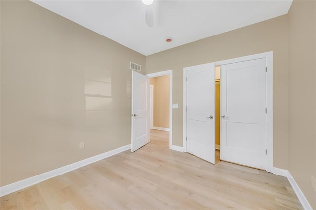 1013 S Main St, Holden, MO 64040 - unfurnished bedroom with baseboards, visible vents, and light wood-style flooring