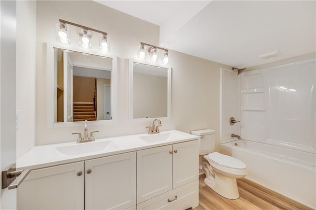 1013 S Main St, Holden, MO 64040 - bathroom featuring wood finished floors, toilet, double vanity, and a sink