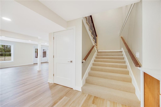 1013 S Main St, Holden, MO 64040 - stairway with baseboards, wood finished floors, and recessed lighting