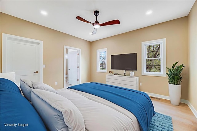 1013 S Main St, Holden, MO 64040 - bedroom featuring multiple windows, light wood-type flooring, a ceiling fan, recessed lighting, and connected bathroom