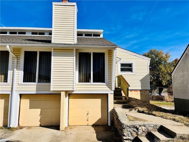 back of house featuring a garage