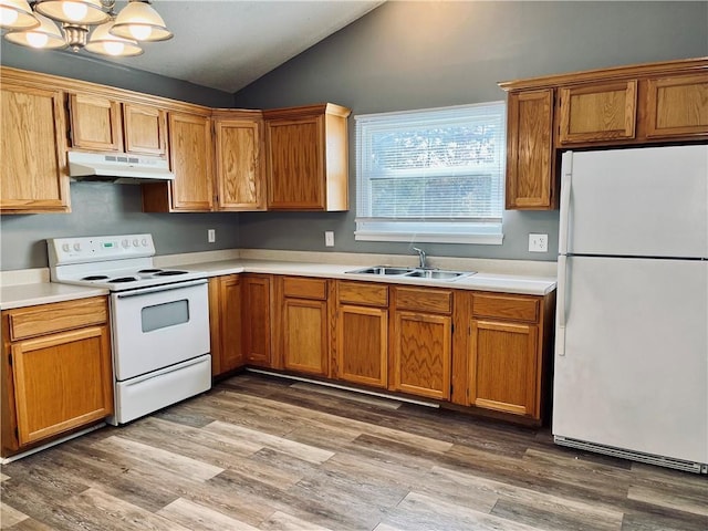 kitchen featuring vaulted ceiling, sink, light wood-type flooring, a chandelier, and white appliances