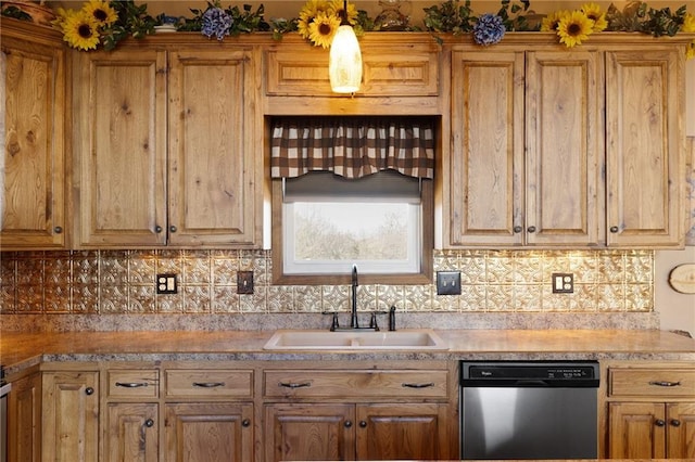 kitchen featuring a sink, tasteful backsplash, light countertops, and stainless steel dishwasher