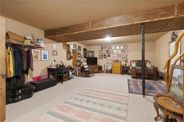 finished basement with a textured ceiling and carpet flooring