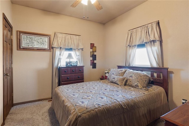 bedroom featuring light colored carpet, ceiling fan, and baseboards