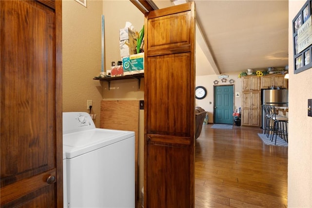 laundry area with laundry area, wood-type flooring, washer / clothes dryer, and a textured wall