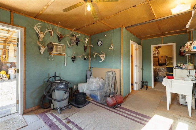 miscellaneous room featuring a wall mounted air conditioner and a ceiling fan