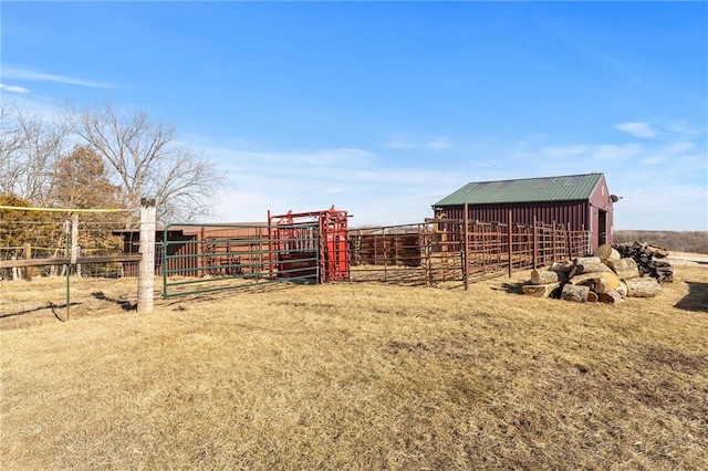 view of yard featuring a rural view, an exterior structure, and an outdoor structure