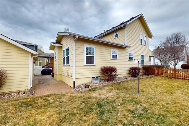 back of house featuring a yard, a patio area, and fence