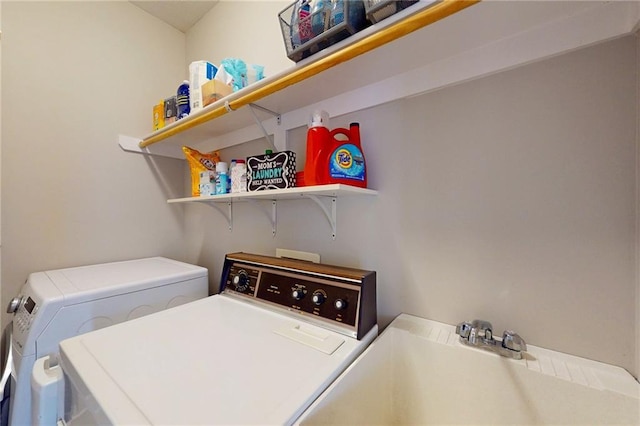 laundry room featuring laundry area, a sink, and washer and clothes dryer