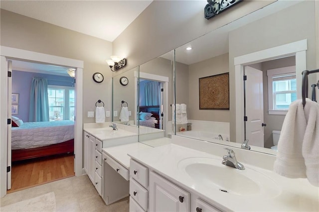 ensuite bathroom with vanity, ensuite bath, and a bath