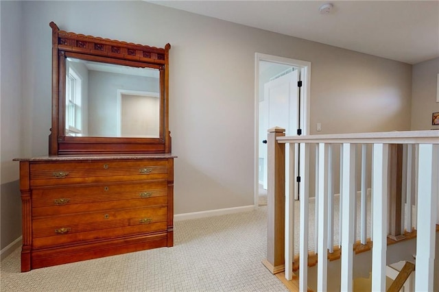 corridor with light carpet and baseboards