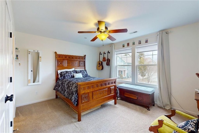 bedroom with a ceiling fan, light colored carpet, visible vents, and baseboards