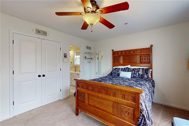 bedroom featuring light carpet, ensuite bath, visible vents, and ceiling fan