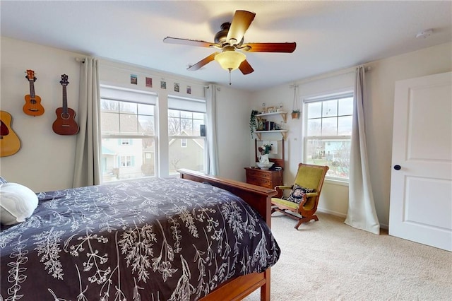 bedroom with ceiling fan, carpet flooring, and baseboards