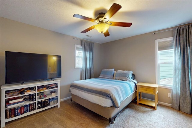 bedroom featuring visible vents, multiple windows, baseboards, and carpet flooring