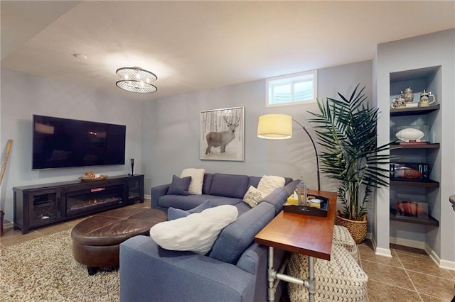 living room featuring baseboards and tile patterned floors