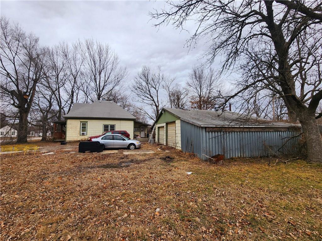 exterior space featuring a detached garage and an outdoor structure